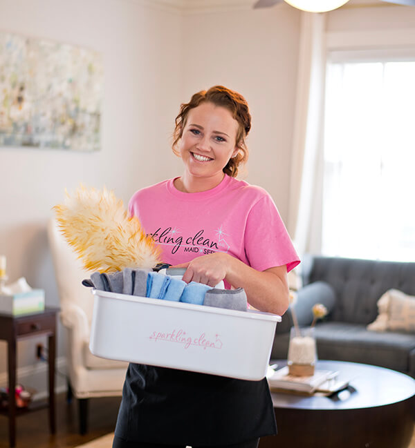 Cleaning tech smiling while holding supplies